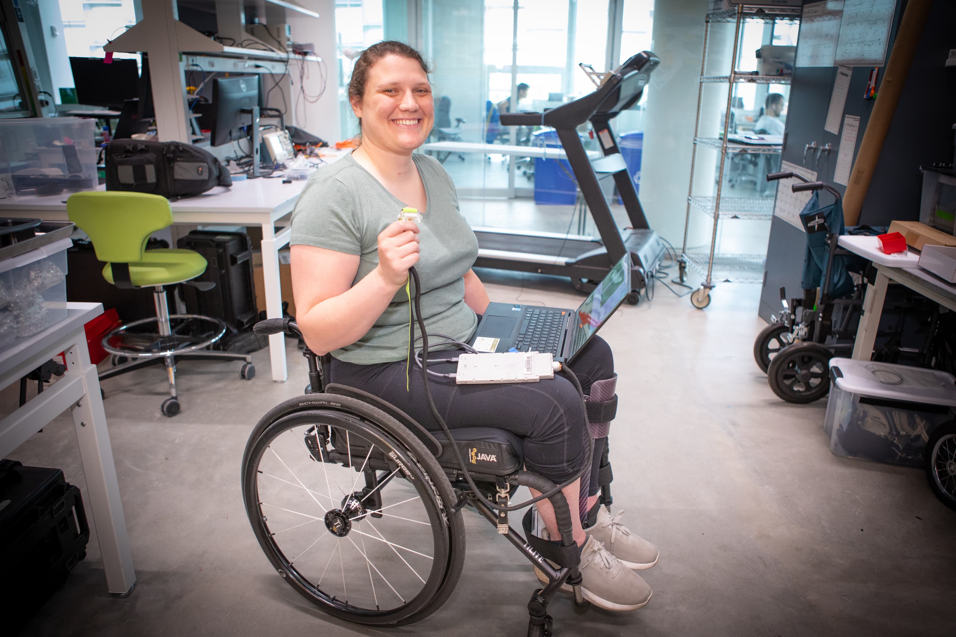 A researcher in a wheelchair testing sensor hardware in a biomedical engineering lab